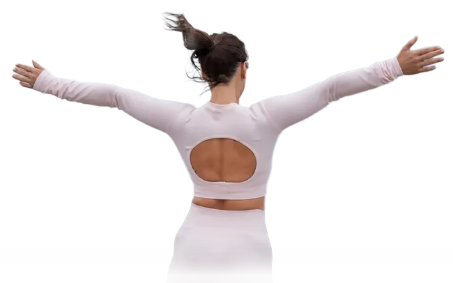 Person seen from behind with arms outstretched, wearing a white top with an open-back cutout.