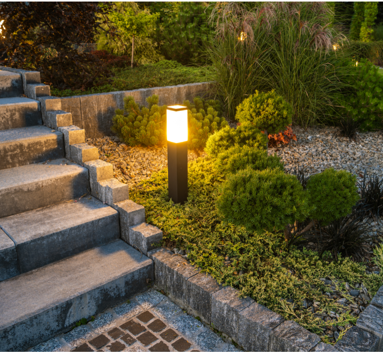 A garden with stairs and a lamp in the middle