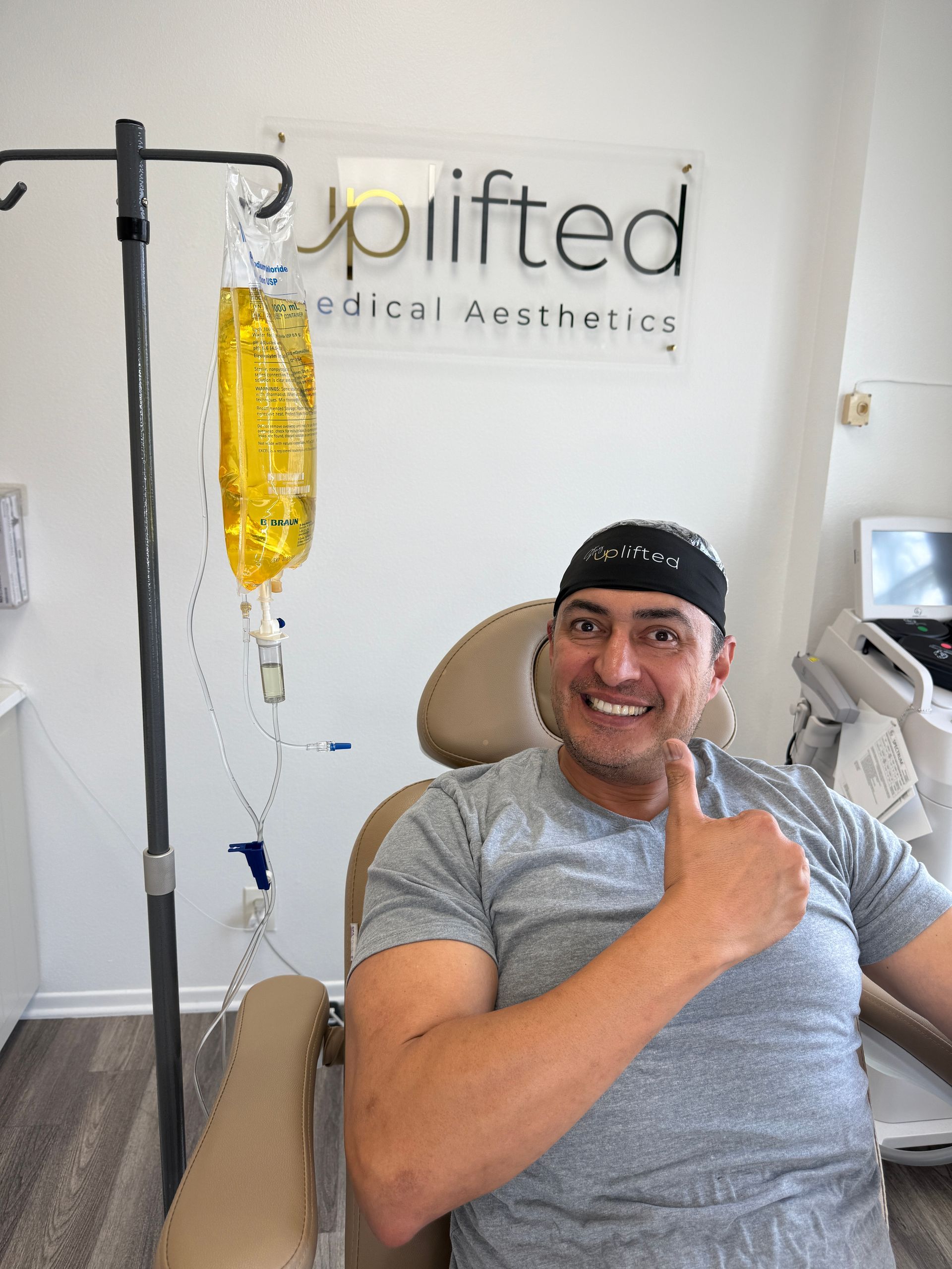 IV bag filled with lemon and lime slices, hanging from a medical stand.