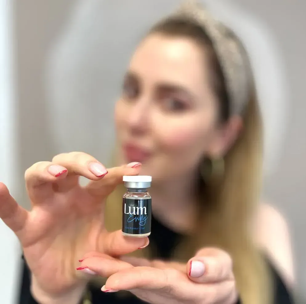 Woman holding a small vial labeled