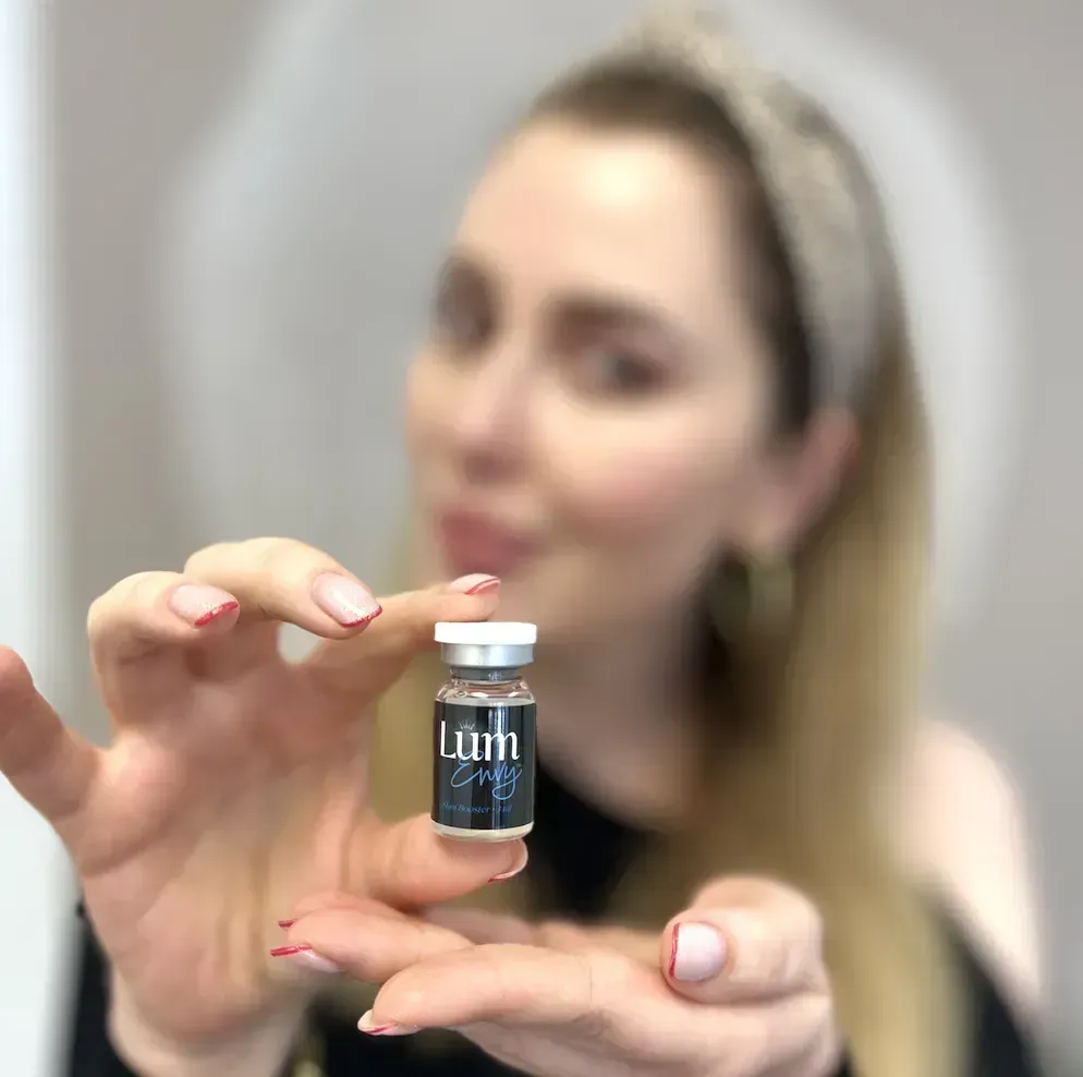 Woman holding a vial labeled 