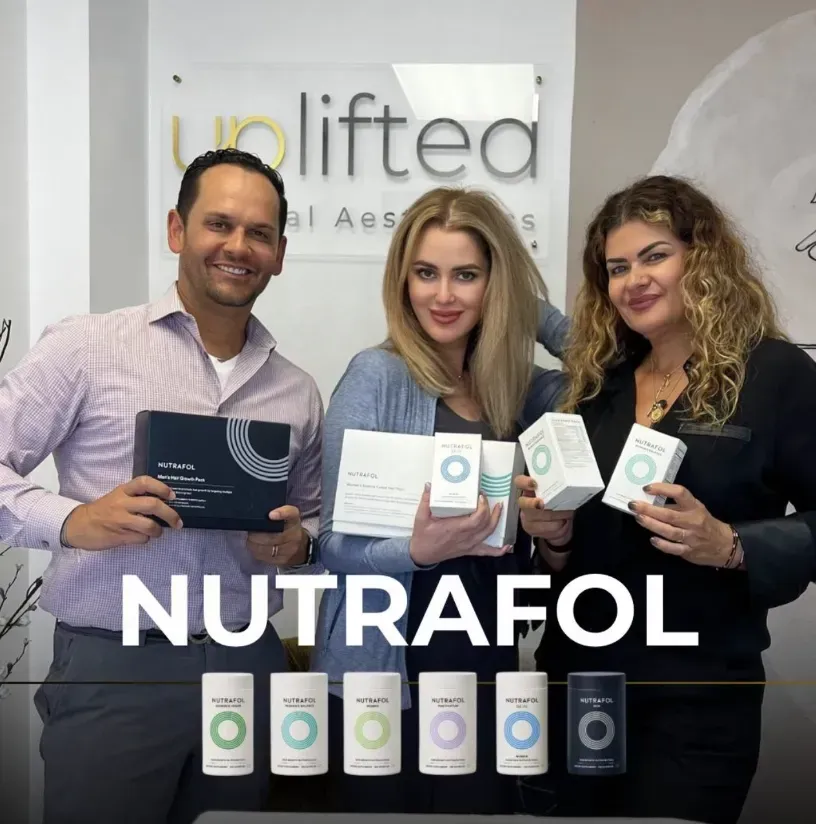 Three people hold Nutrafol product boxes in a business setting.