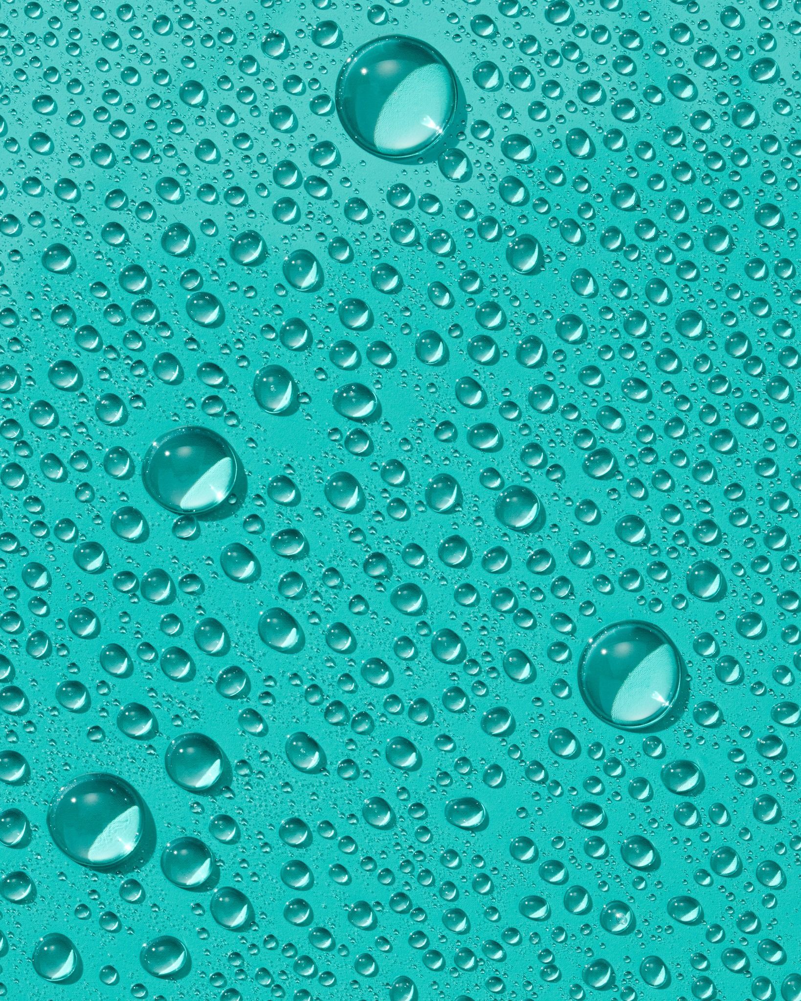 Water droplets on a teal surface.