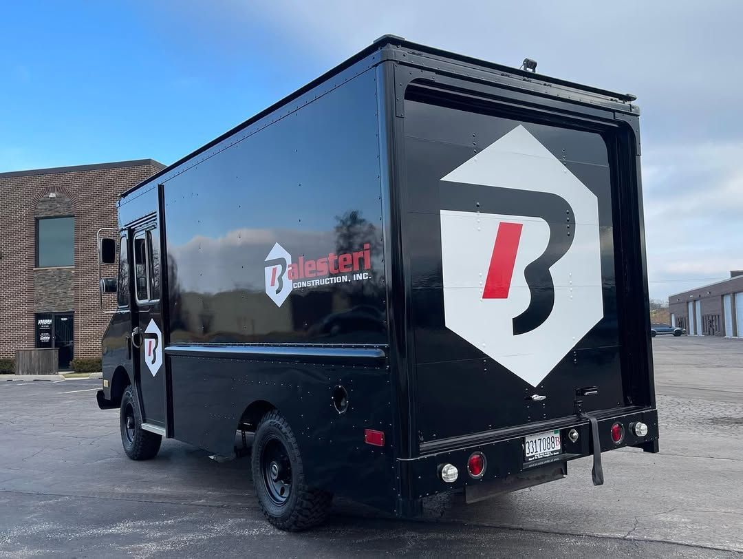 Black box truck with white and red 