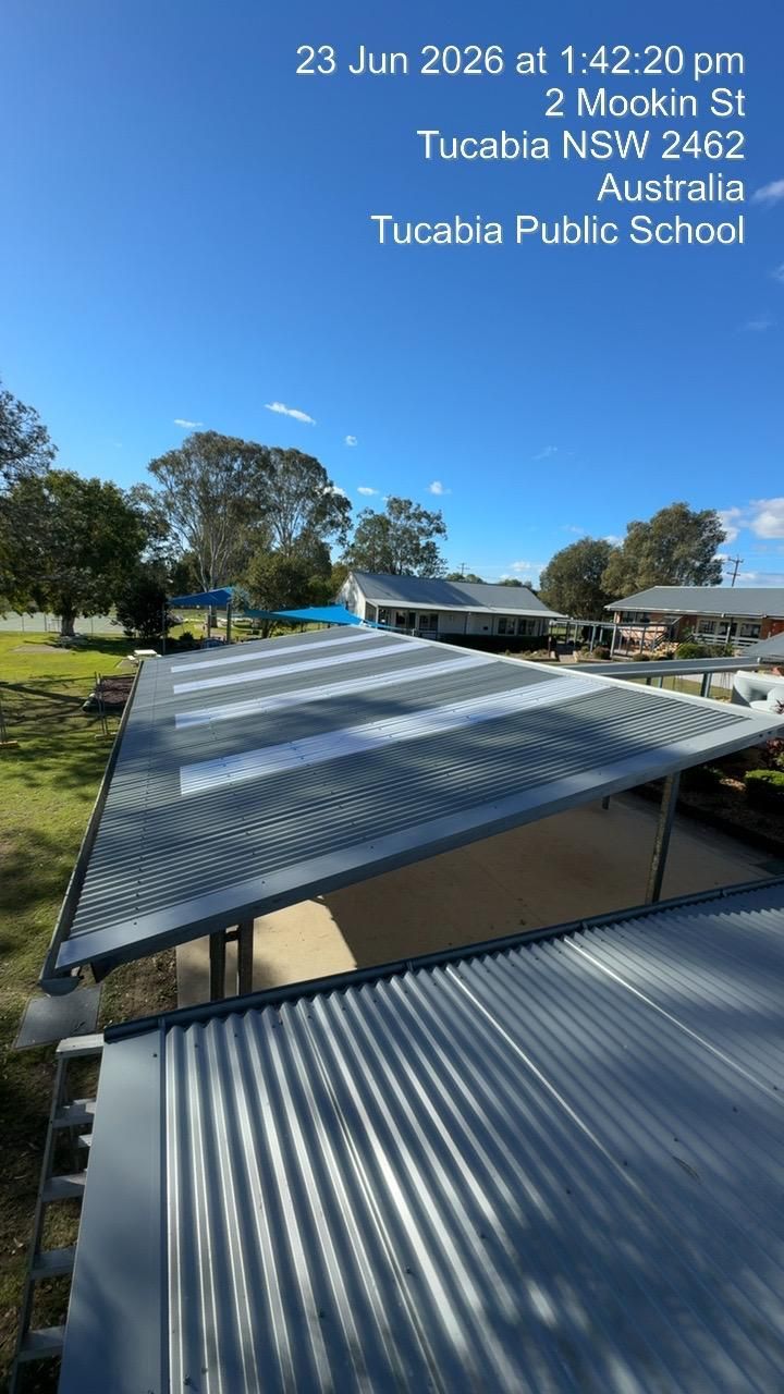 School rooftops with corrugated metal in a sunny outdoor view at Tuckaia Public School, Australia