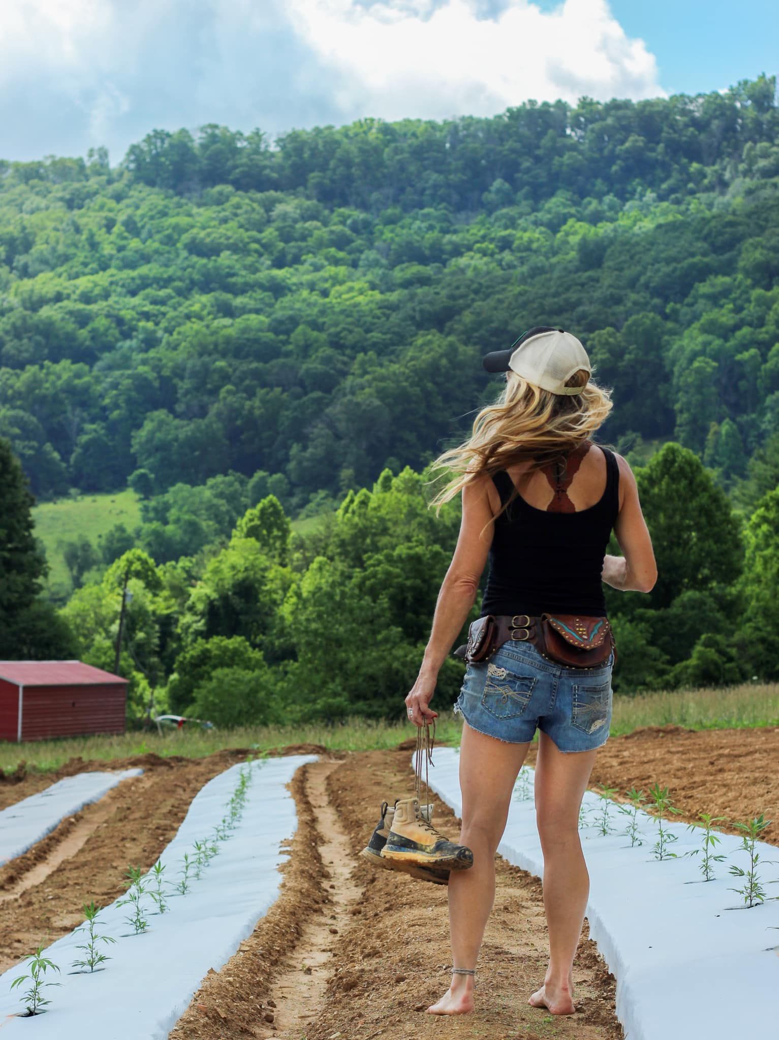 Franny Tacy CEO of Franny's Farmacy smelling outdoor grown hemp plants