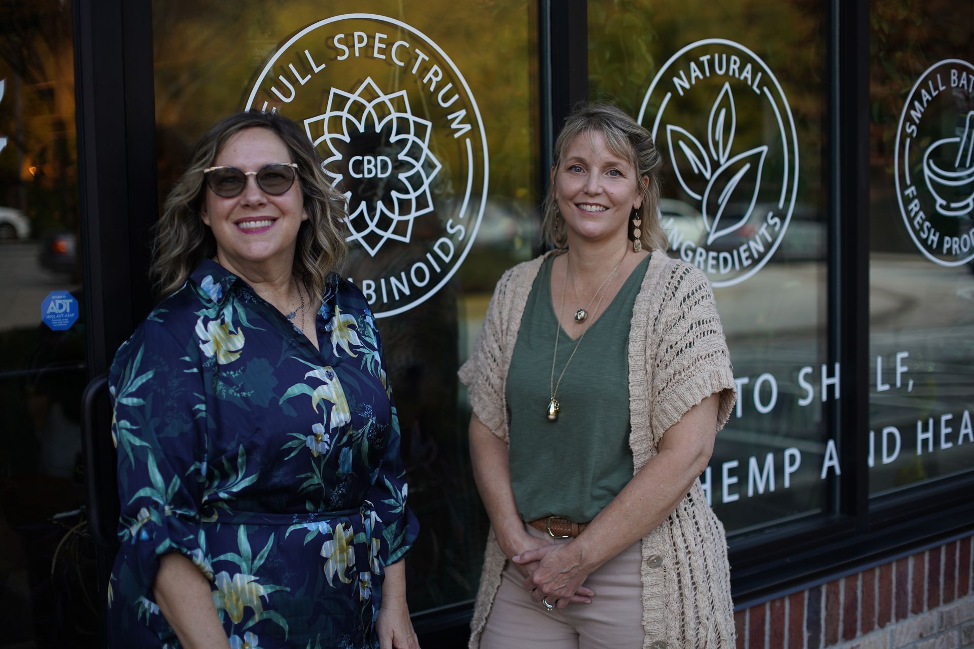 Owners of top hemp dispensary in Cary NC standing outside their storefront