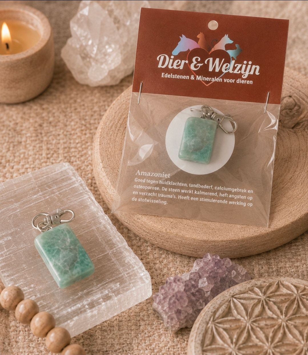 Sieraden met kristallen hangers worden tentoongesteld op kaartjes, naast een kaars, kristallen en een houten onderzetter.