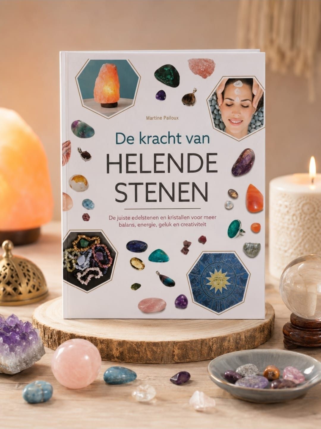 Book cover titled “De kracht van helende stenen” surrounded by crystals and candles on a tabletop.