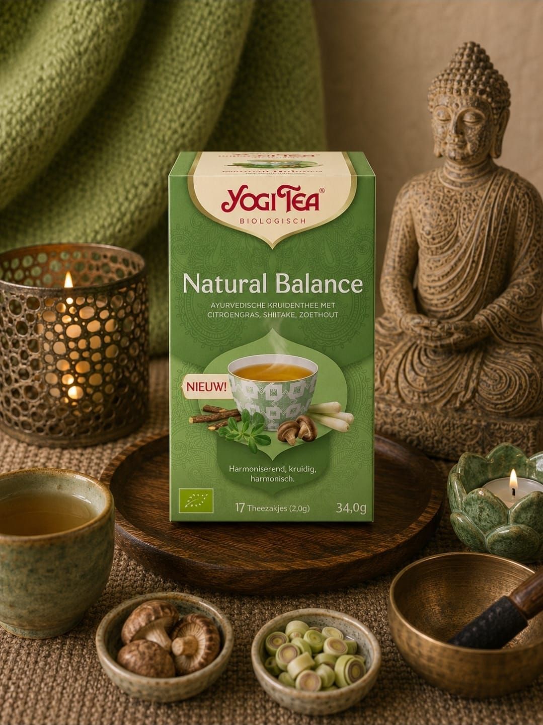 Een doos Yogi Tea Nature's Balance op een spatafel met kaarsen, schalen en een Boeddhabeeld.