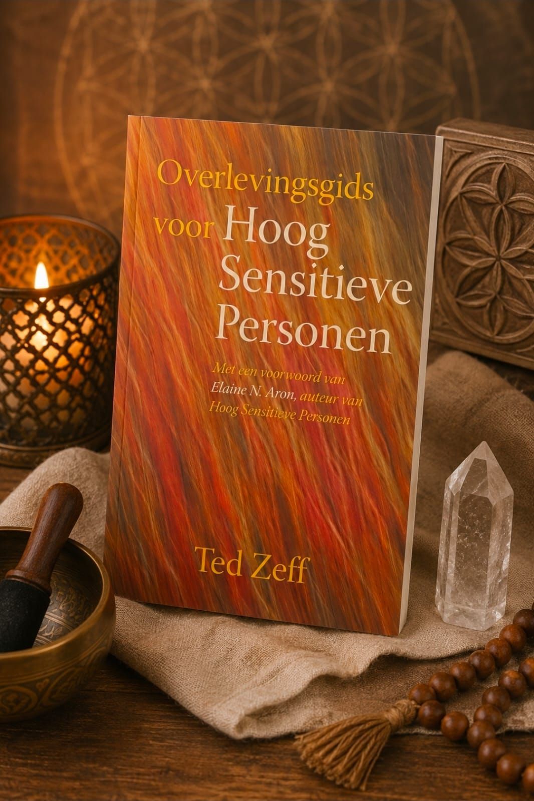 Book cover titled “Overlevingsgids voor Hoog Sensitieve Personen” on a warm-lit table with crystals and herbs