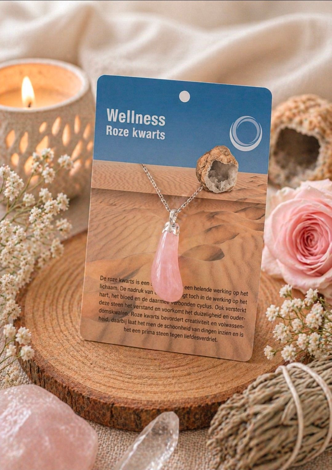Wellness rozenkwarts ketting tentoongesteld op een houten standaard met kaarsen en roze bloemen.