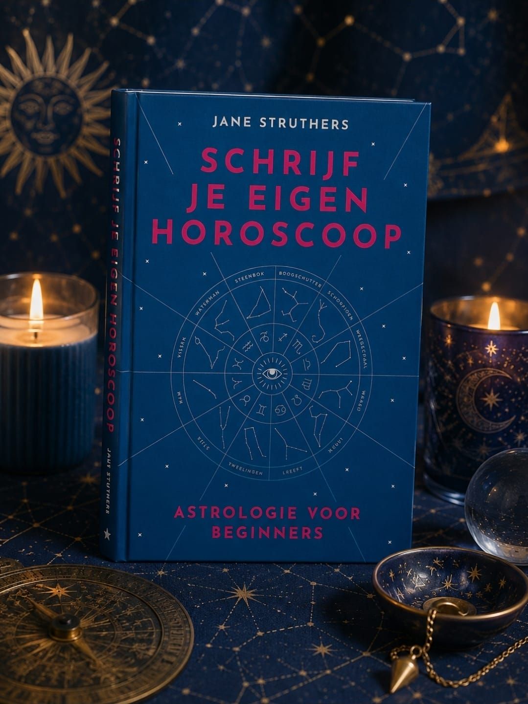 Blue astrology book “Schrijf je eigen horoscoop” on a starry table with candles and zodiac decor