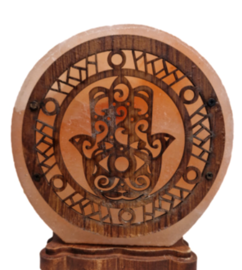 Houten Hamsa wanddecoratie met ingewikkelde zwarte uitsparingen, tentoongesteld op een glazen plank.