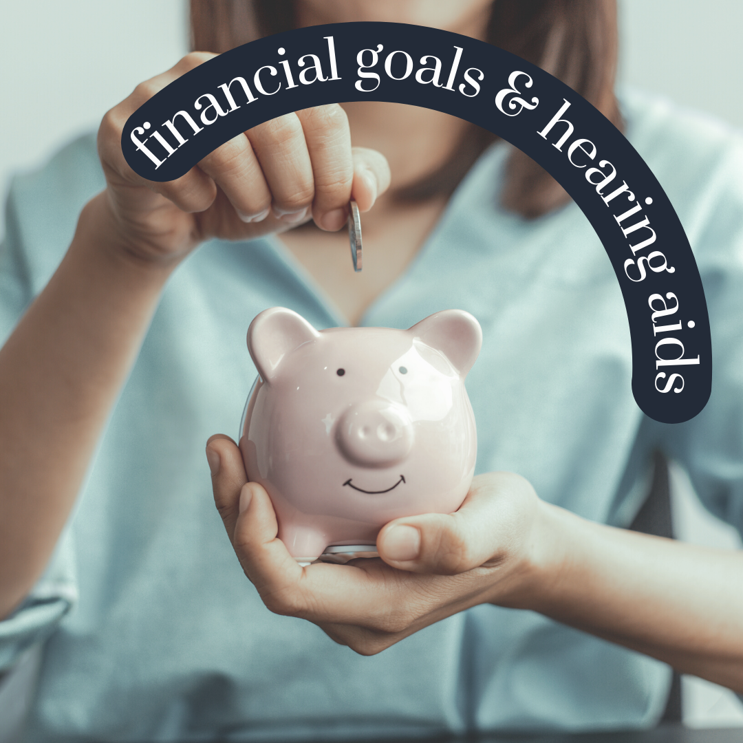 A woman is putting a coin into a piggy bank that says financial goals & hearing aids