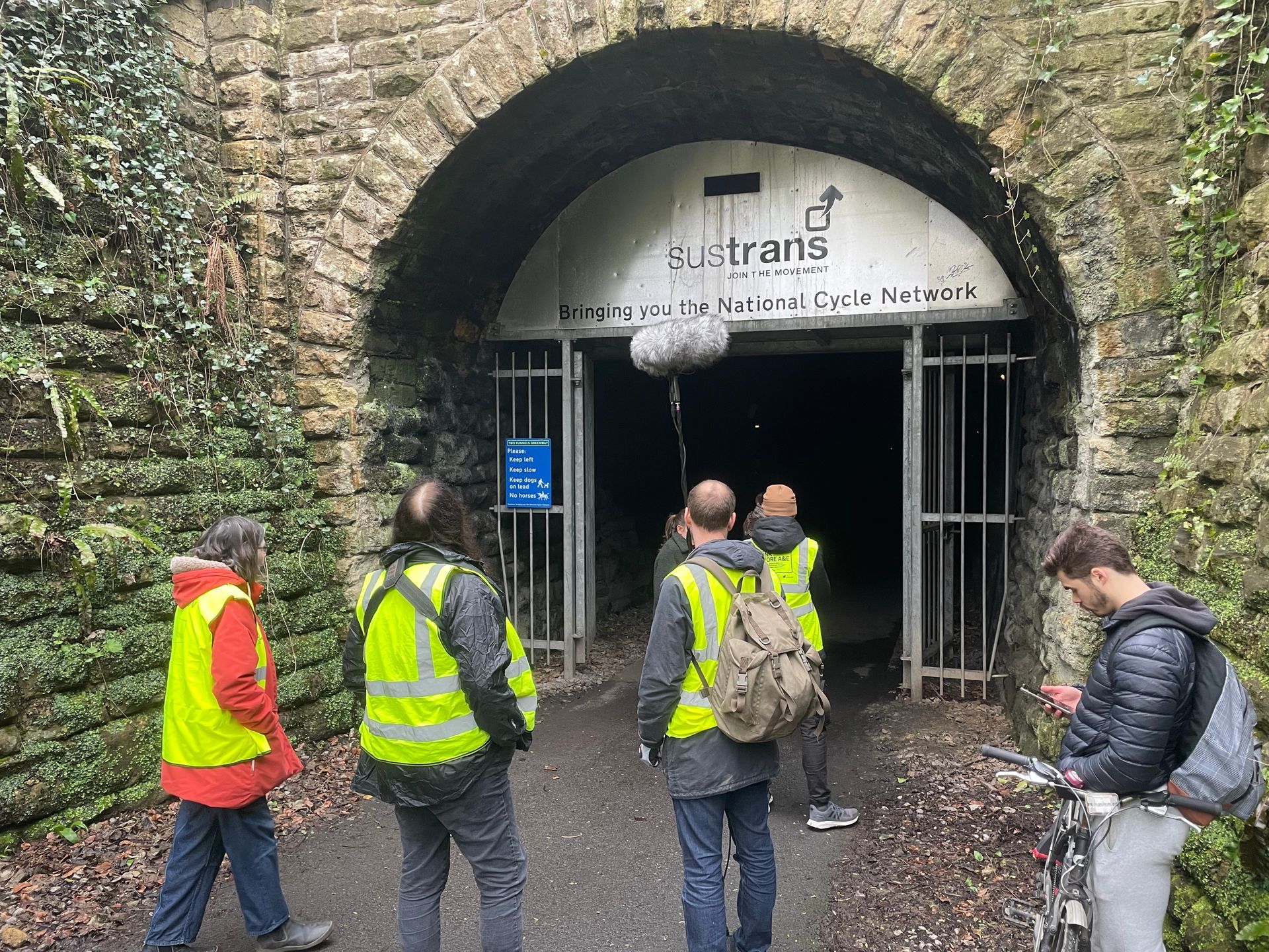 A film crew in Hi Vis outside a tunne.