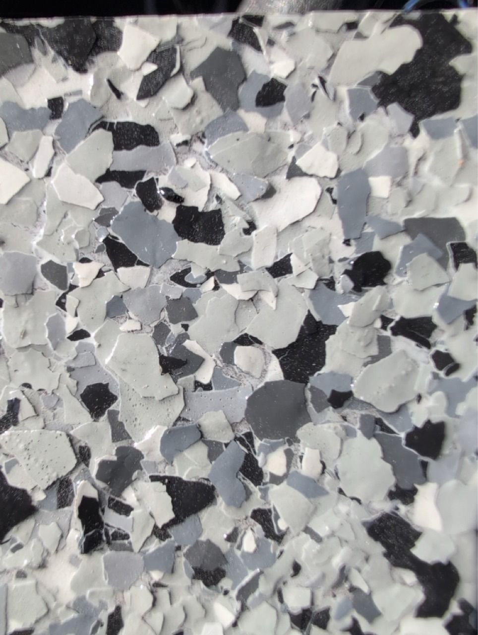 Abstract close-up of gray, white, and black speckled textured surface