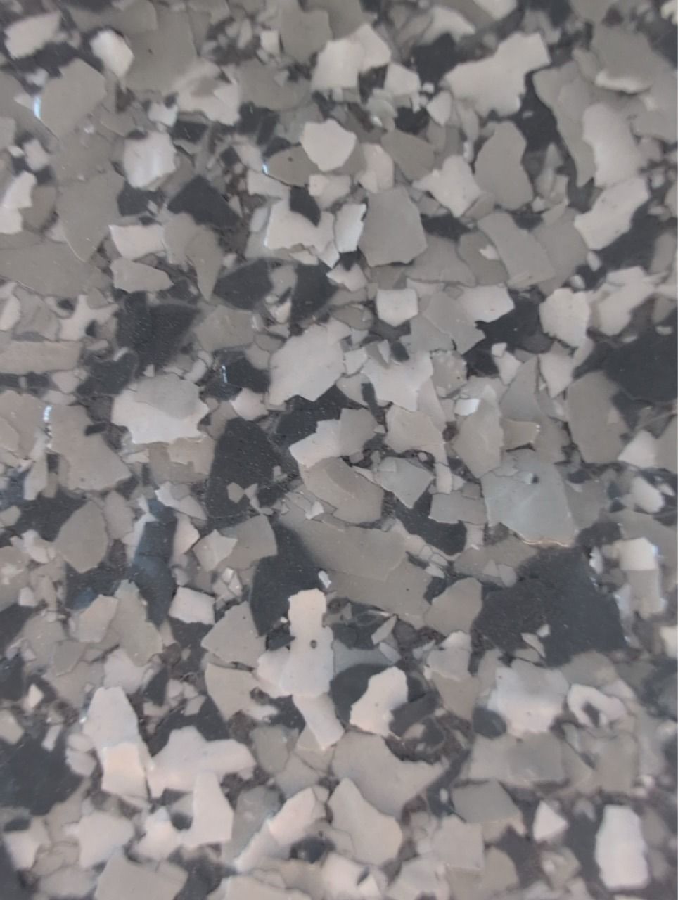 Gray and white speckled stone or terrazzo surface texture