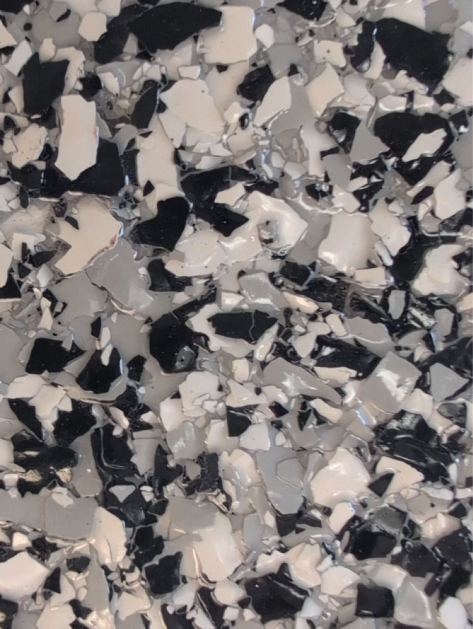 Black, gray, and white speckled terrazzo-like surface pattern