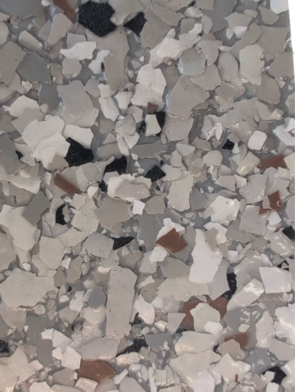 Close-up of gray, white, and brown speckled stone or terrazzo surface