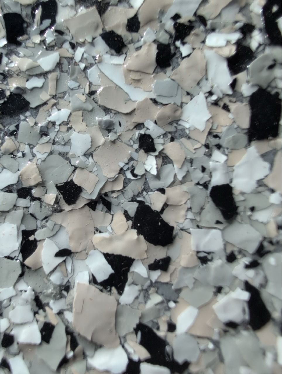 Close-up of a speckled gray, black, and white stone or terrazzo surface