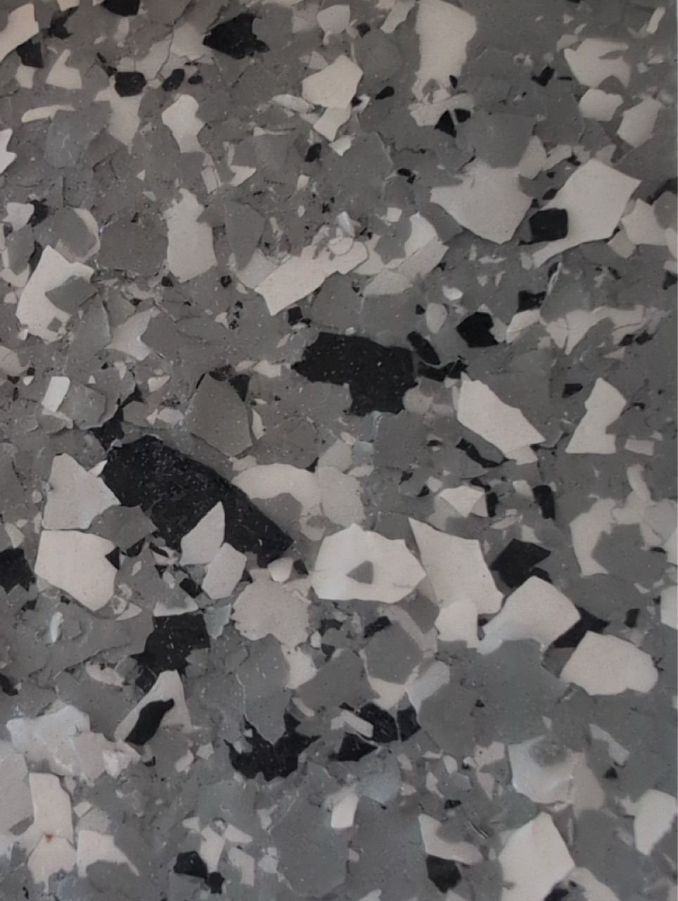 Close-up of speckled gray, black, and white terrazzo flooring texture