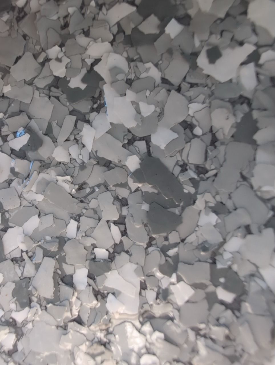 Close-up of scattered gray and white crushed stones or gravel.