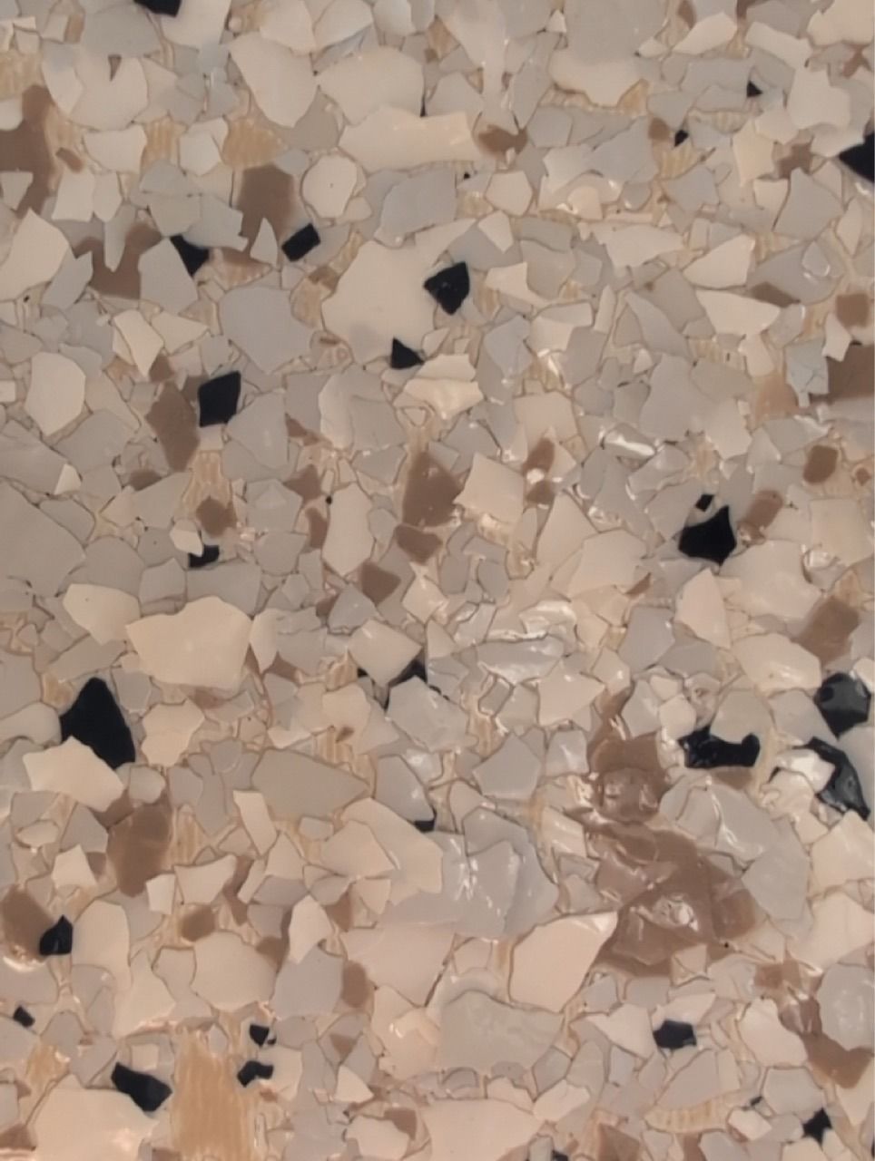 Beige terrazzo floor with scattered black, tan, and white stone chips