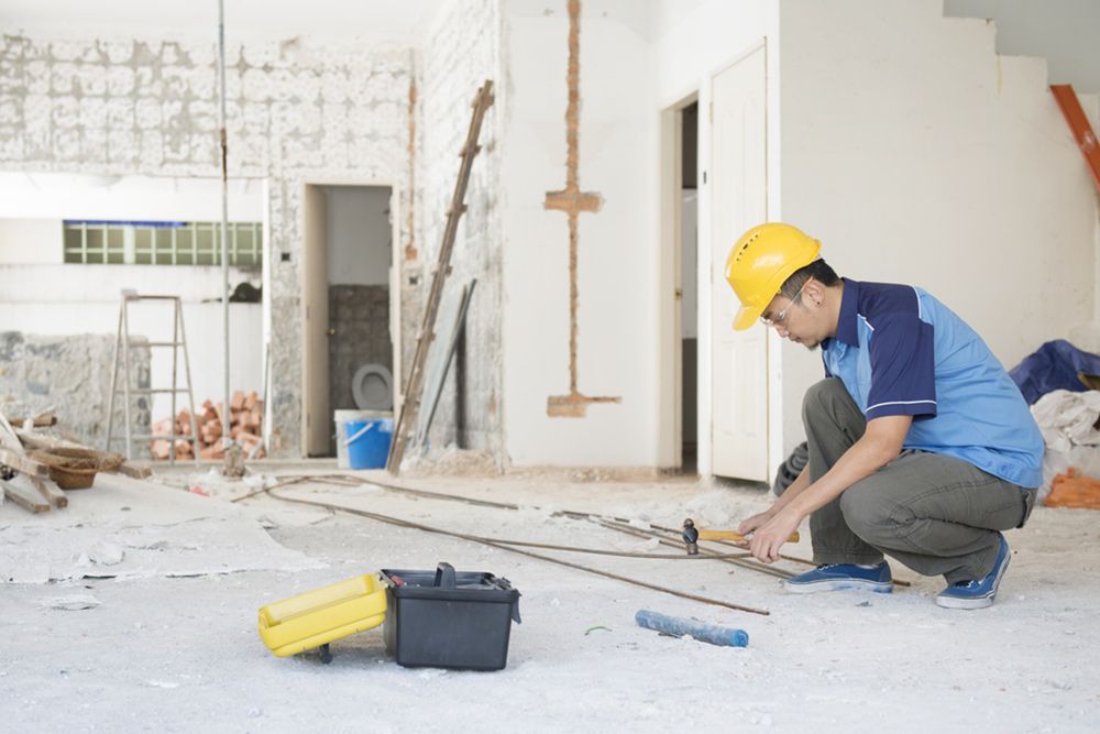 Man Using Hammer for the Steels to be Place in the House — Builder in Seventeen Seventy, QLD