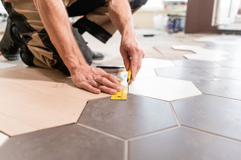 Man Cutting the Vinyl Using Cutter — Builder in Seventeen Seventy, QLD