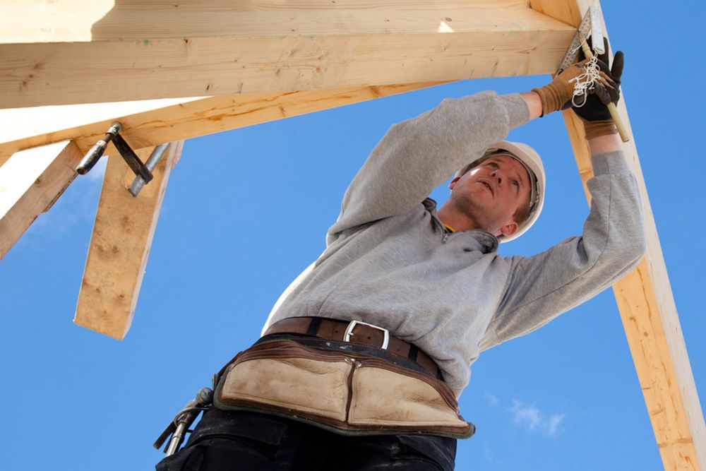 Man Fixing the Structure of the House — Builder in Lowmead, QLD