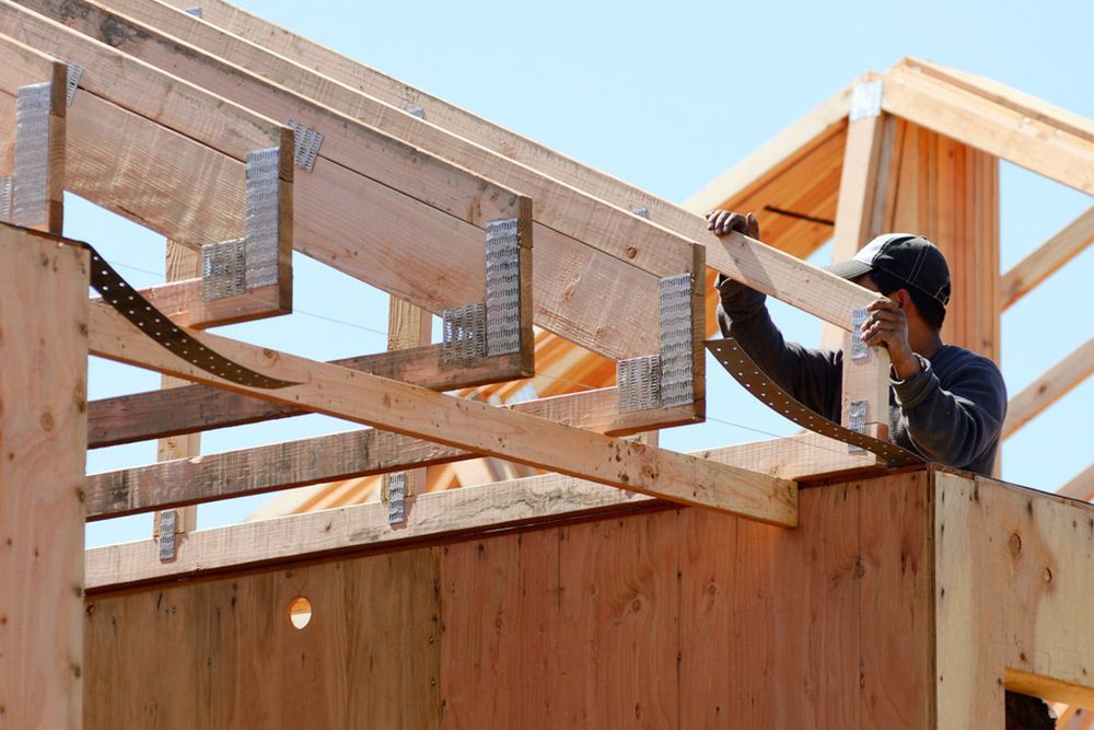 Man fixing the roof structure — Builder in Deepwater, QLD