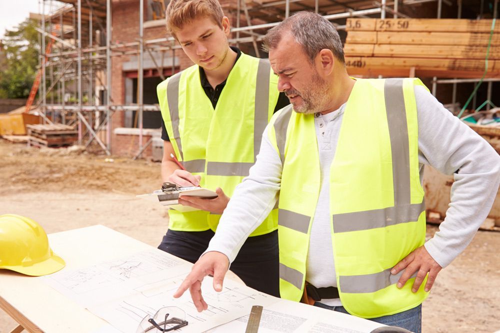 2 Man Checking the Blueprint of the House — Builder in Rosedale, QLD