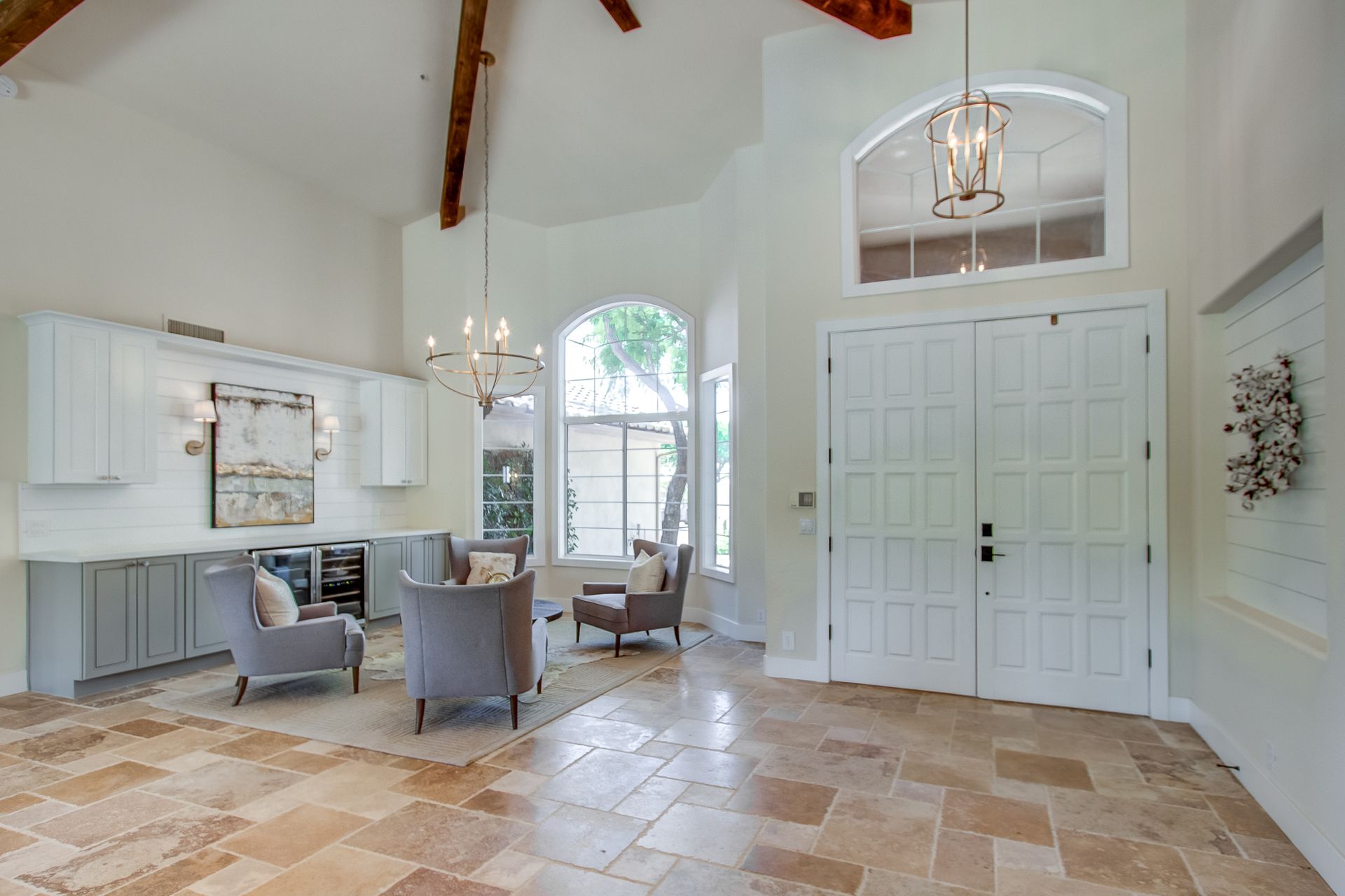 A living room with a lot of furniture and a large window.