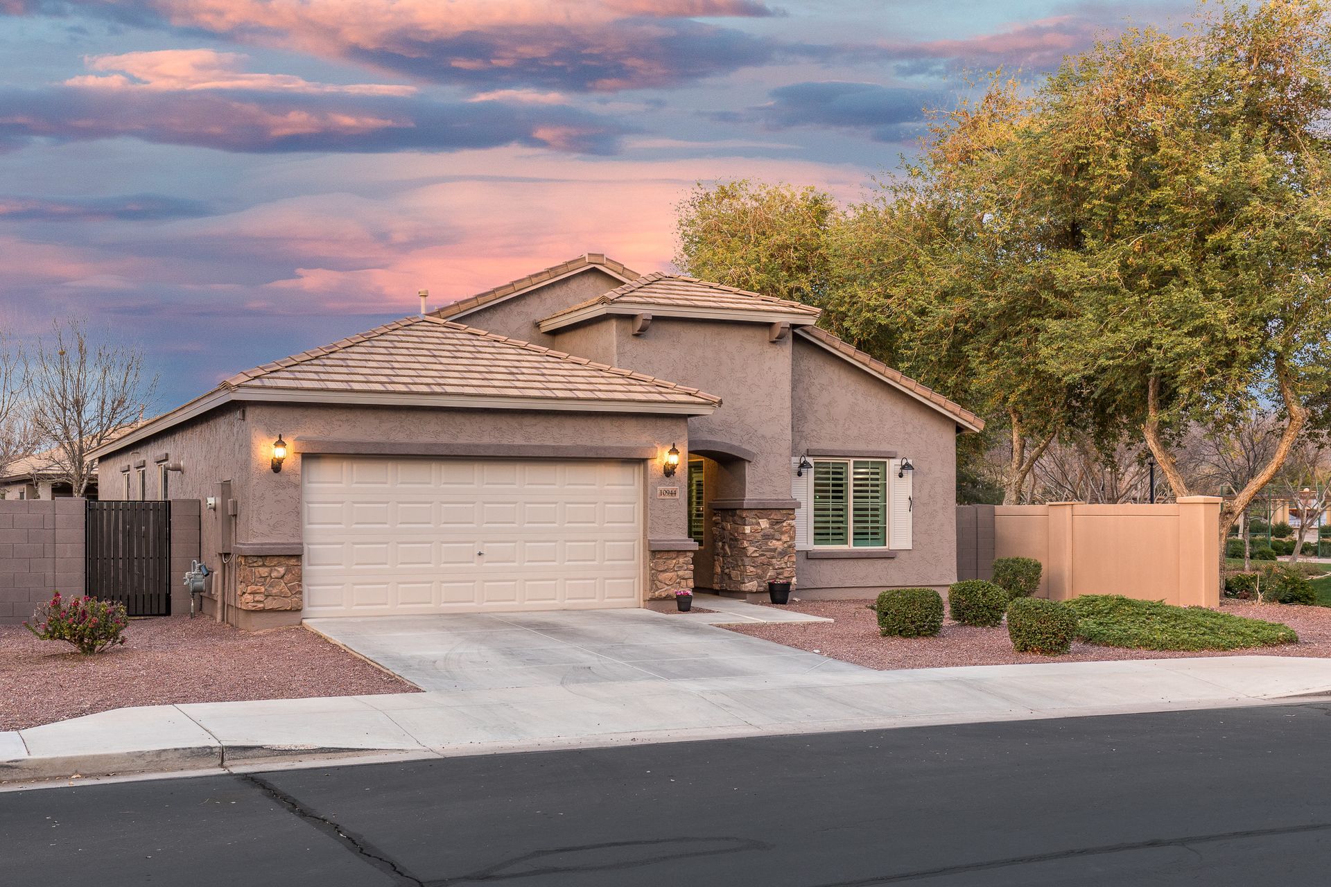 A house with a garage and a driveway in front of it.