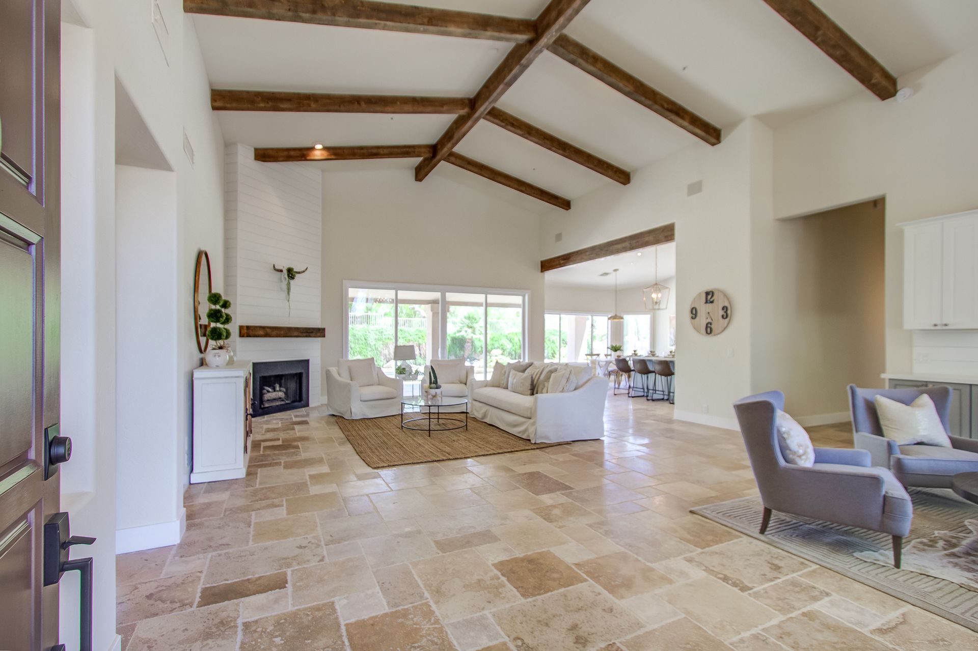 A living room with a couch , chairs , and a fireplace.