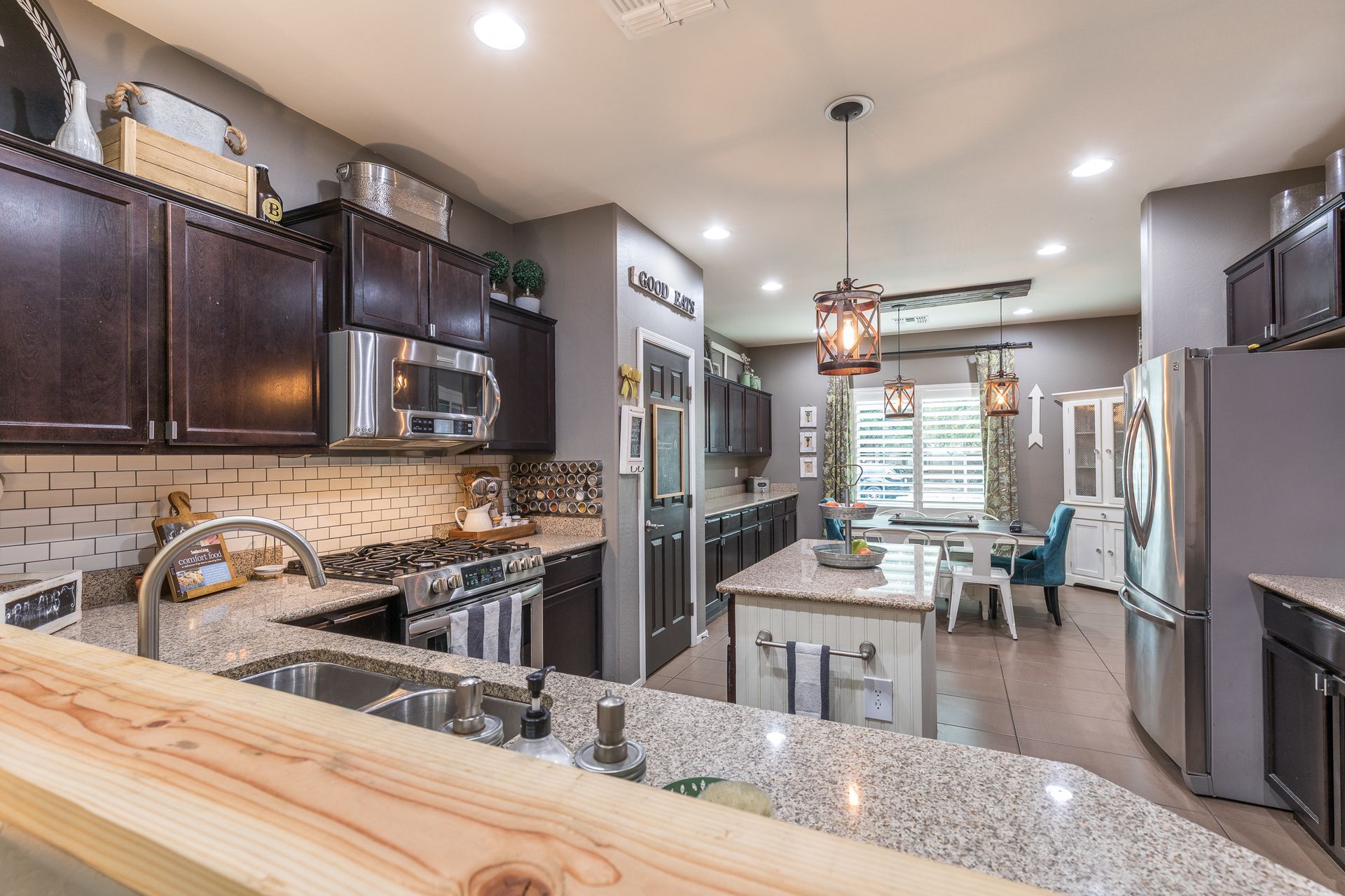 A kitchen with granite counter tops and stainless steel appliances.