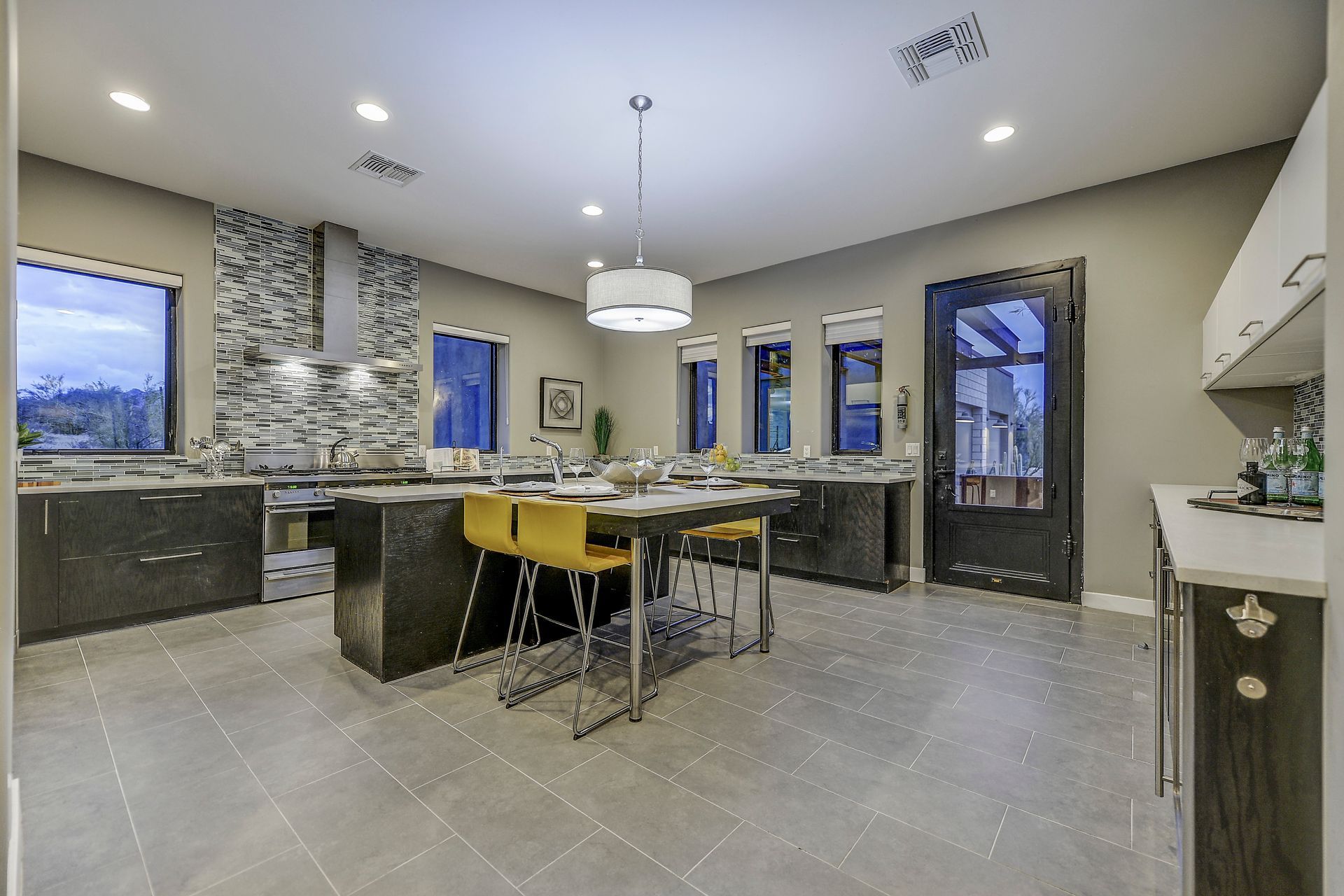A large kitchen with a table and chairs in it.