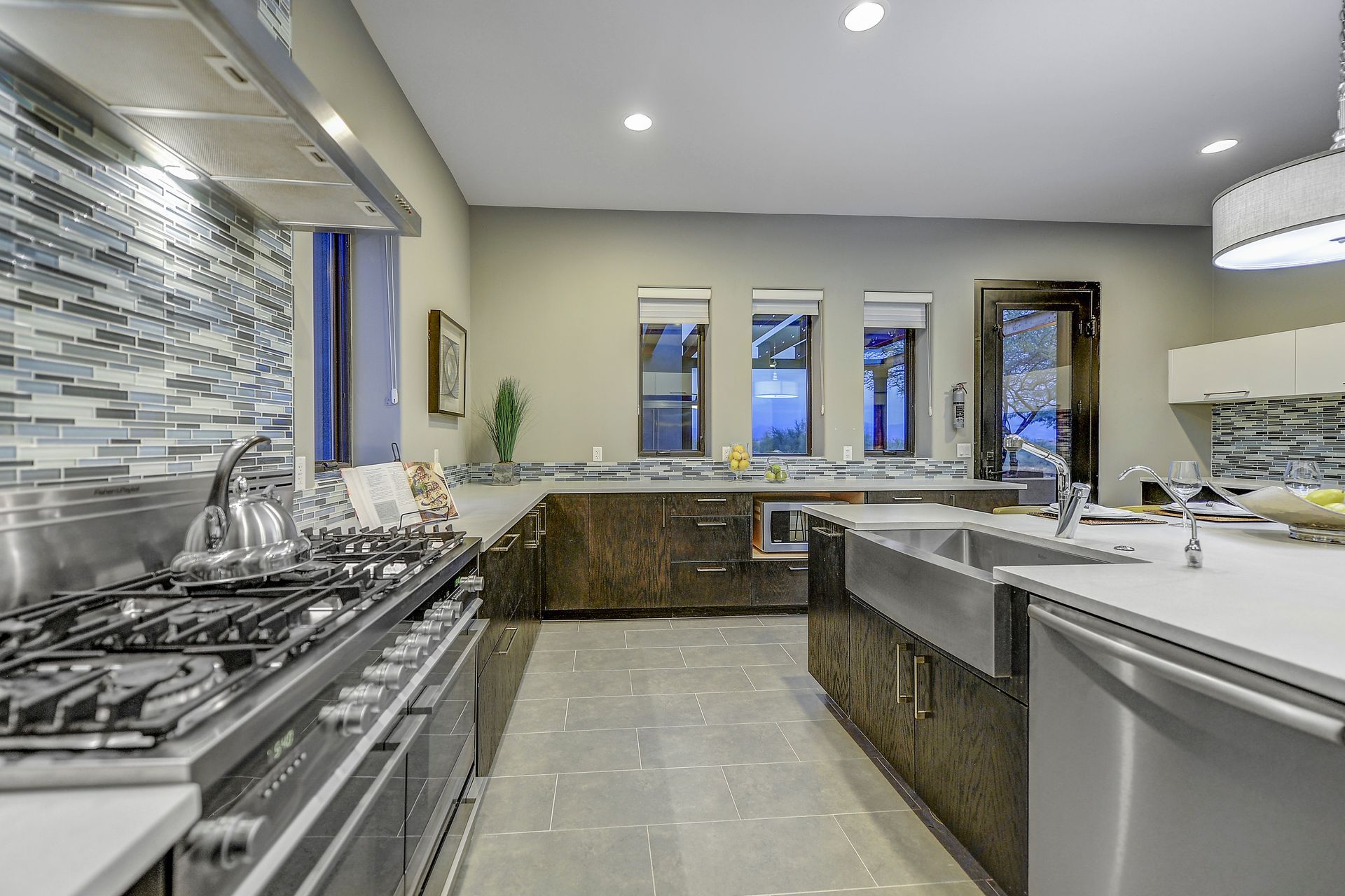 A kitchen with stainless steel appliances and a large island.