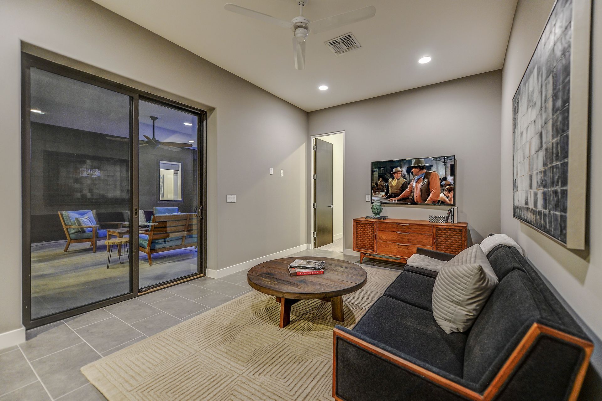 A living room with a couch , table , and television.