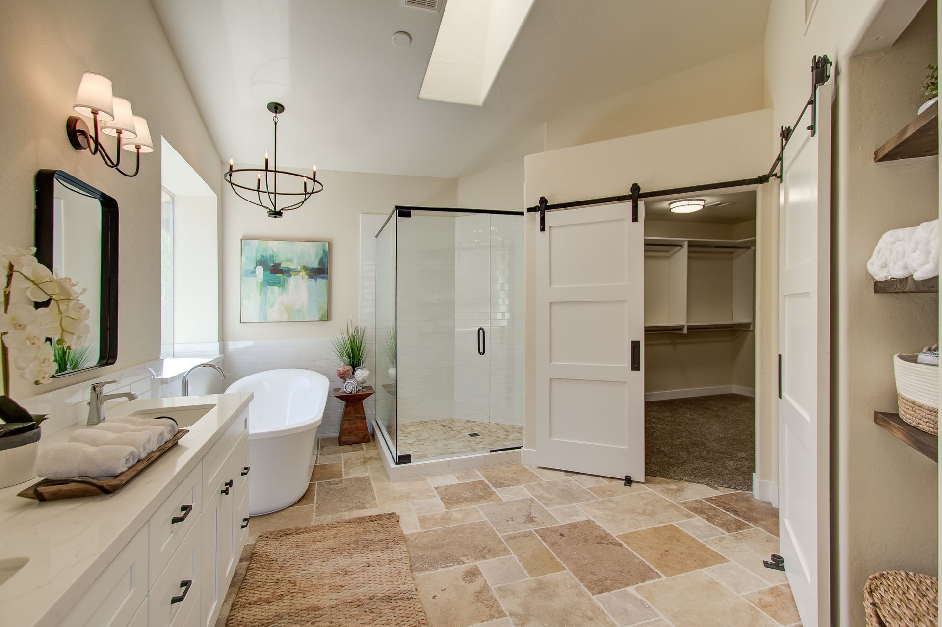 A bathroom with a bathtub and a walk in closet