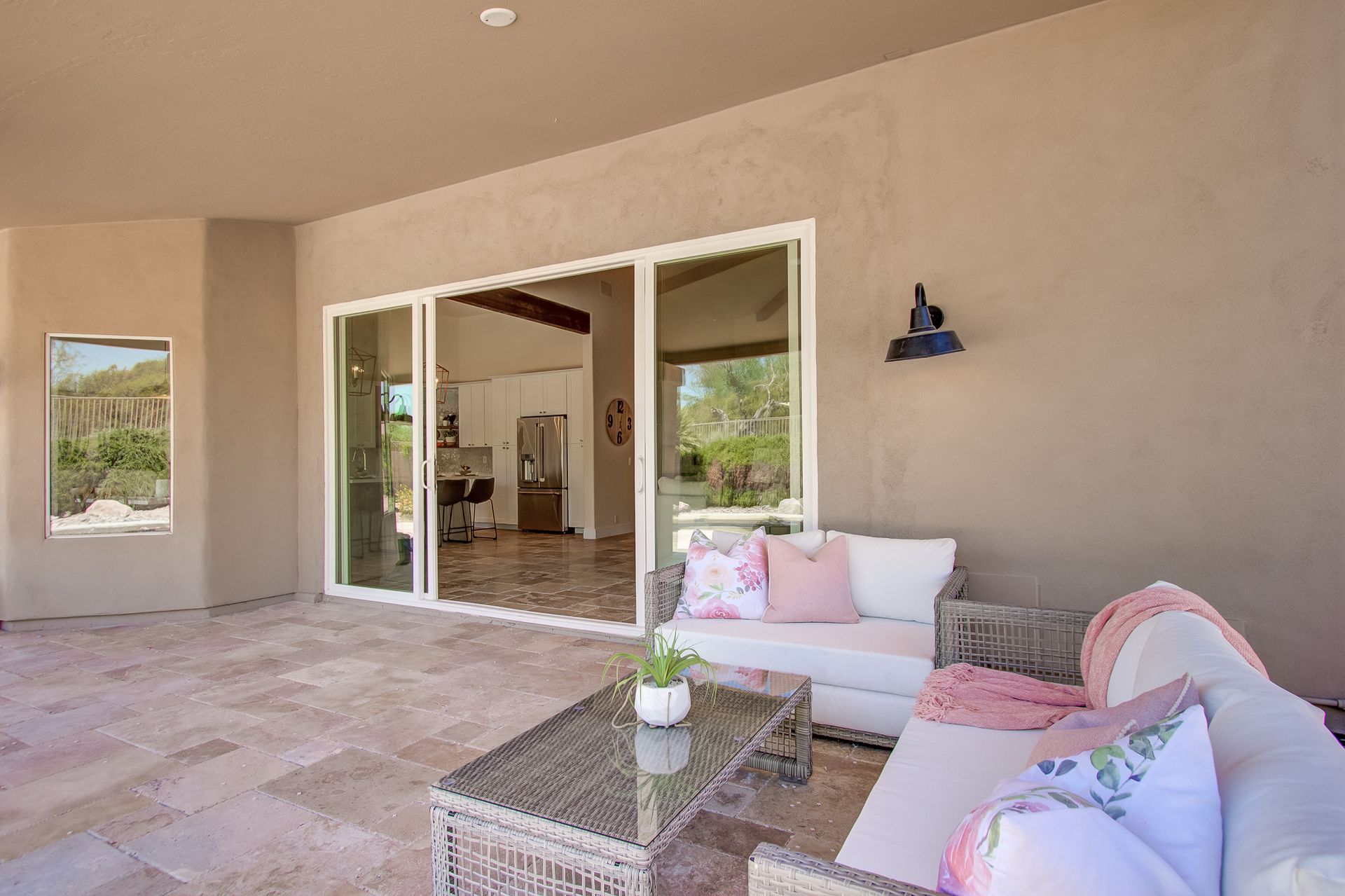 There is a couch and a table on the patio.