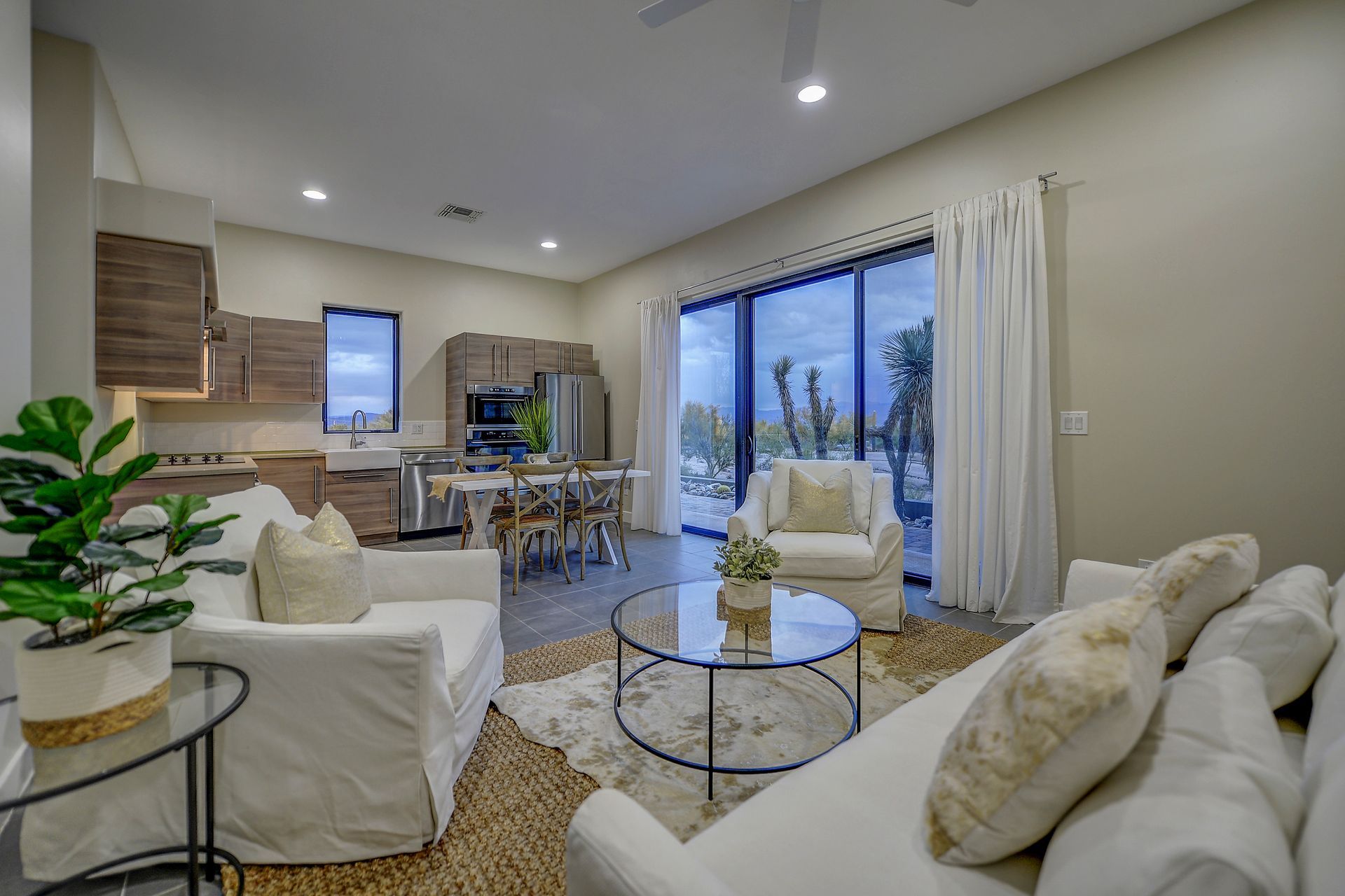 A living room with a couch , chairs , and a coffee table.