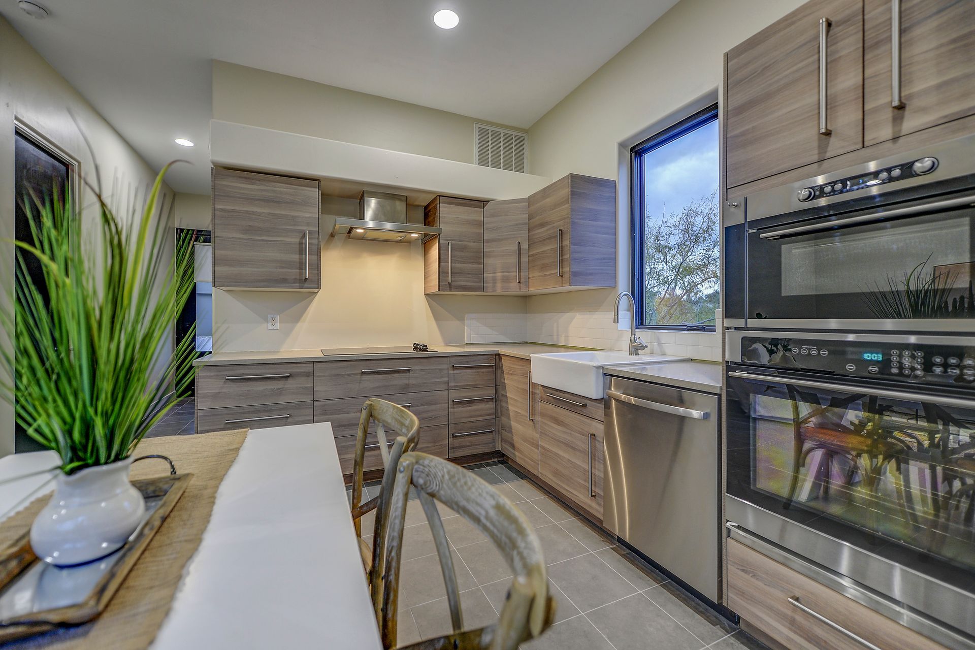 A kitchen with stainless steel appliances and wooden cabinets.