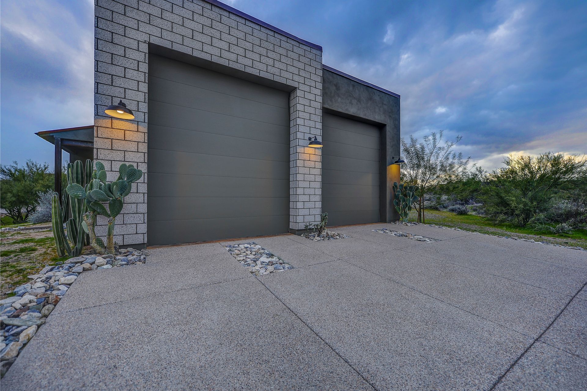 A modern house with two garage doors and a driveway.