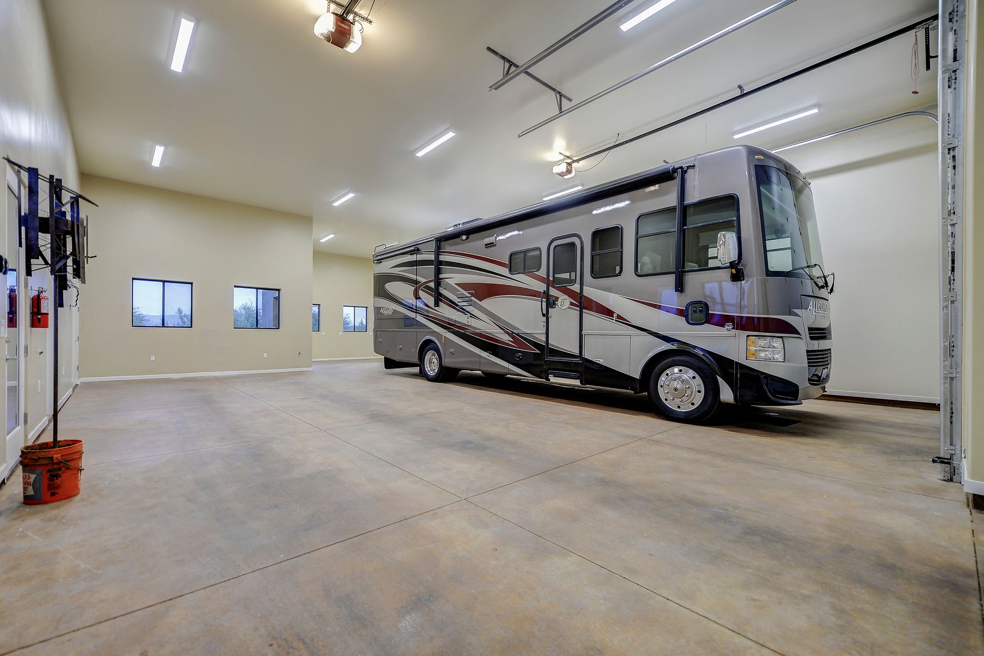 A large rv is parked in a garage.