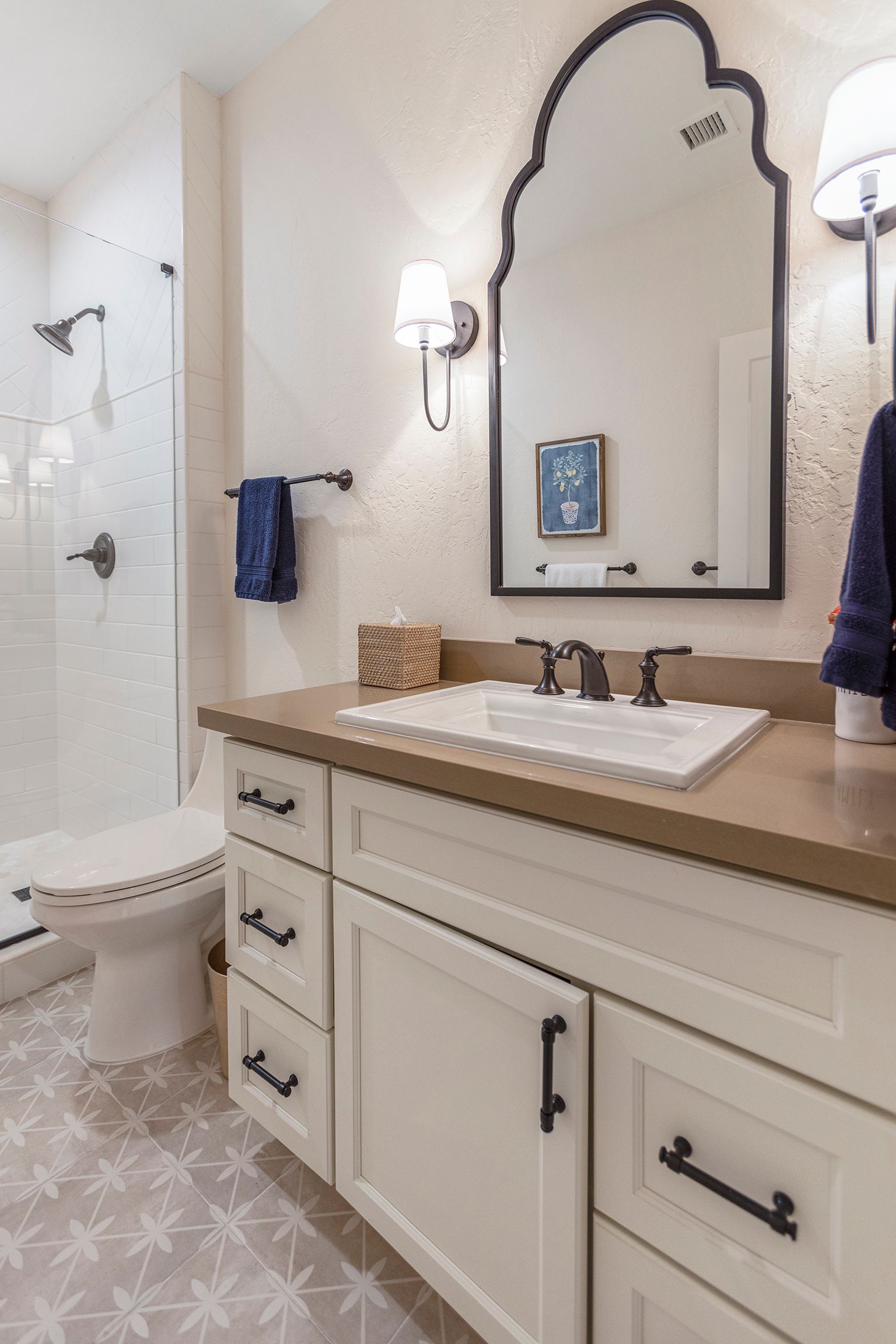 A bathroom with a sink , toilet and mirror.