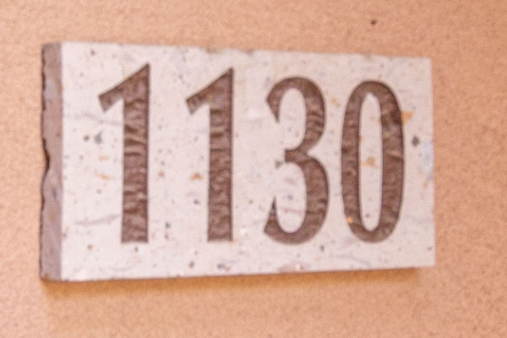 A white sign with the number 1130 on it