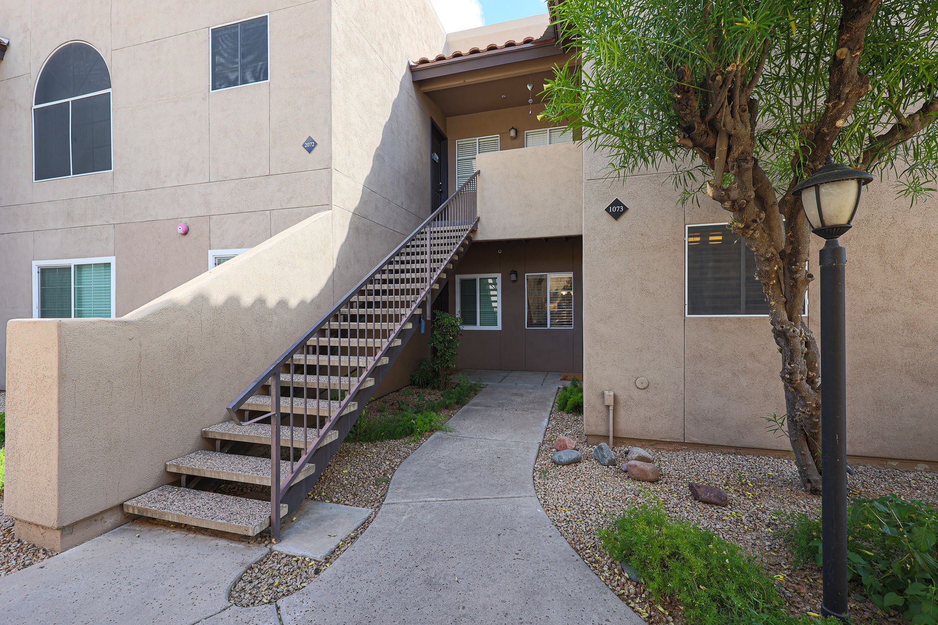 A building with stairs leading up to the second floor