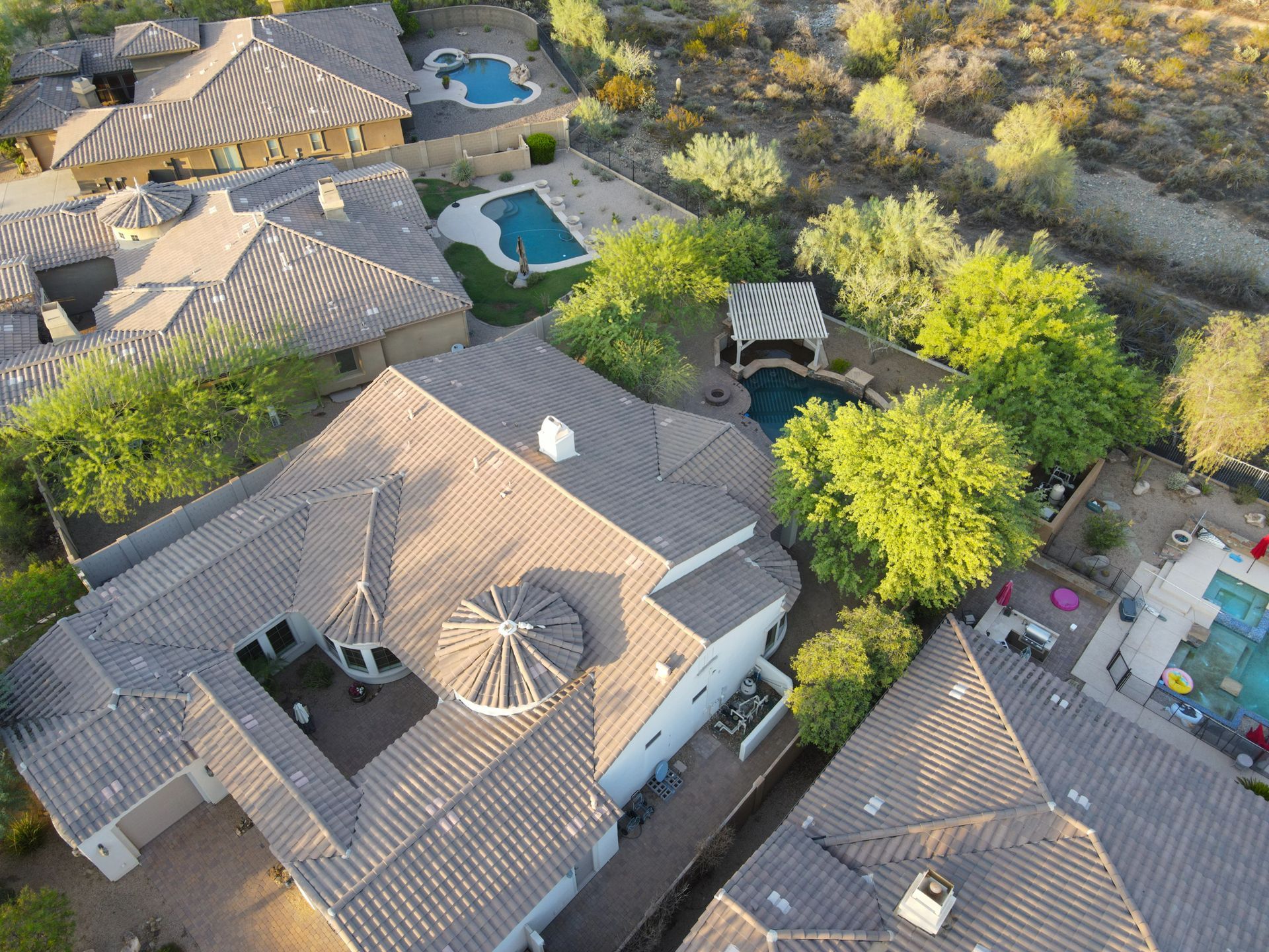 An aerial view of a house with a pool in the backyard